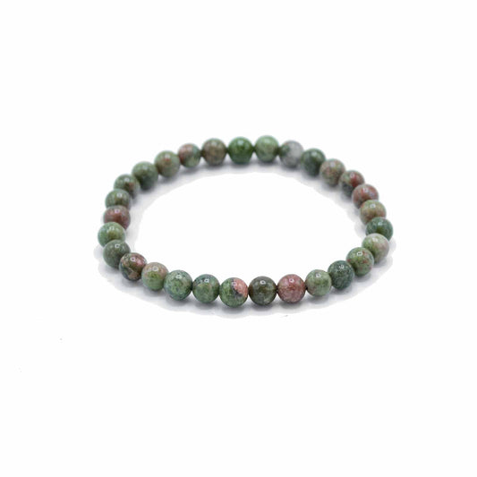 Green beaded bracelet on a white background