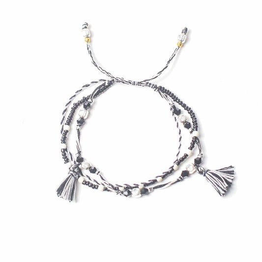 Multi-strand bracelet with tassels on a white background