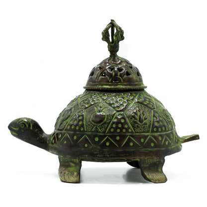 Decorative turtle-shaped object with a lid on a white background