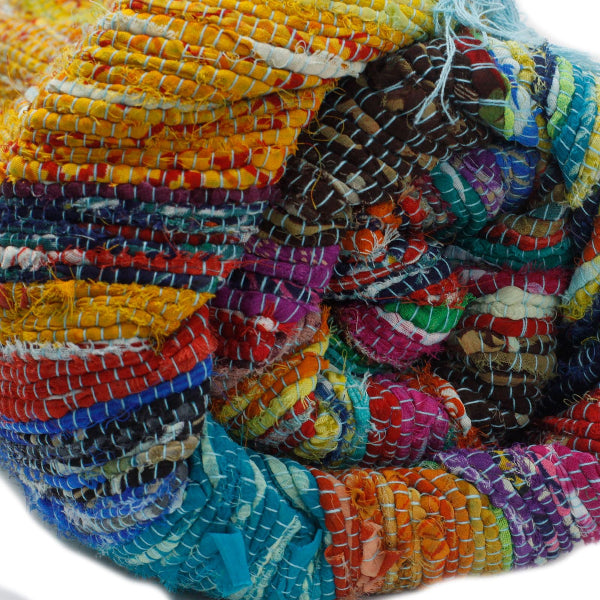 Stack of colorful fabric bangles on a white background
