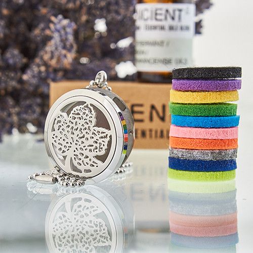 Decorative silver locket with colorful hair ties on a reflective surface.