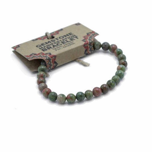 Green gemstone bracelet on a white background with a branded card.