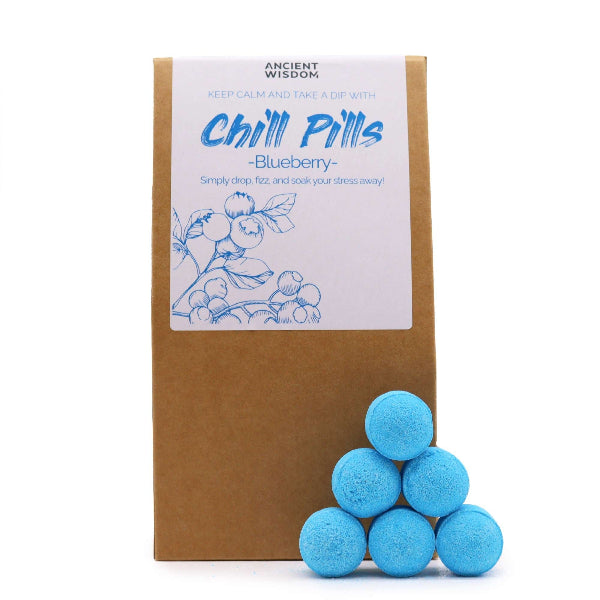 Blue bath bombs in front of a brown box labeled 'Chill Pills Blueberry' on a white background
