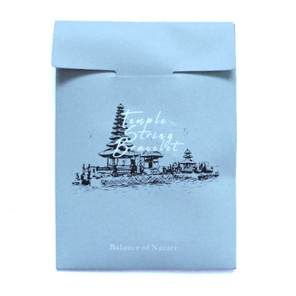 Light blue packaging with temple illustration and text on a white background