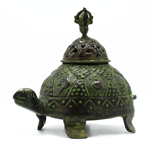 Decorative turtle-shaped object with intricate designs on a white background