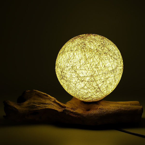 Round woven lamp on a dark background