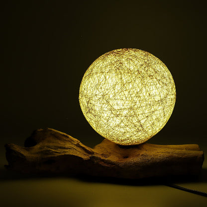 Round woven lamp on a dark background