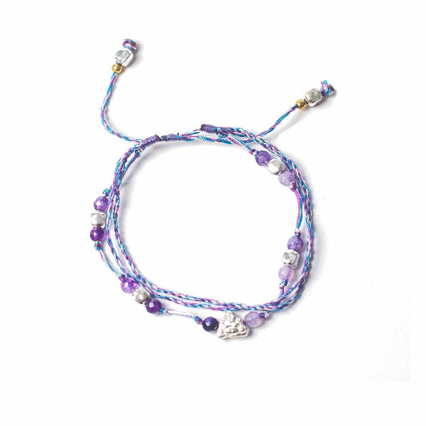 Multistrand bracelet with beads and charms on a white background