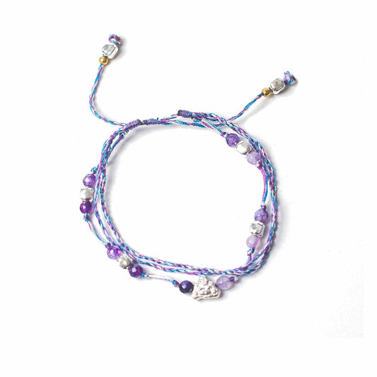 Multistrand bracelet with beads and charms on a white background