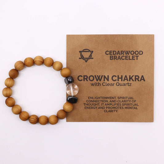 Wooden bracelet with clear quartz bead on a brown card labeled 'Cedarwood Bracelet Crown Chakra' on a white background