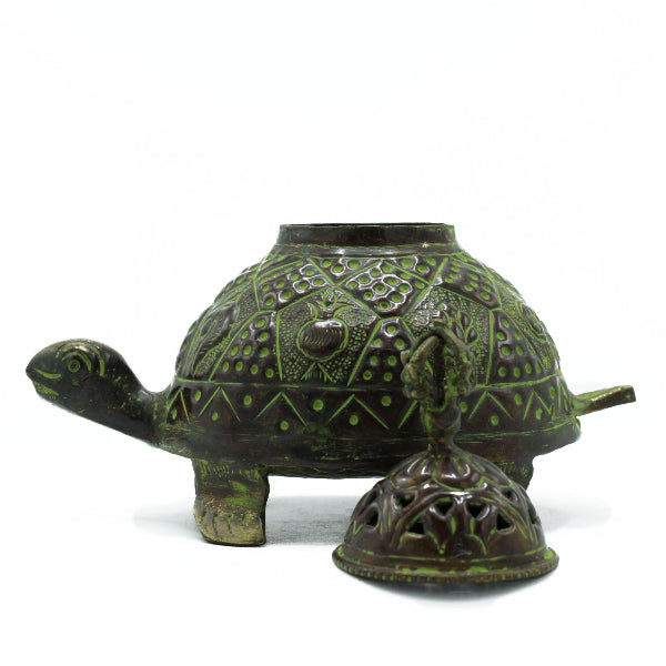 Decorative turtle-shaped pot with intricate patterns on a white background