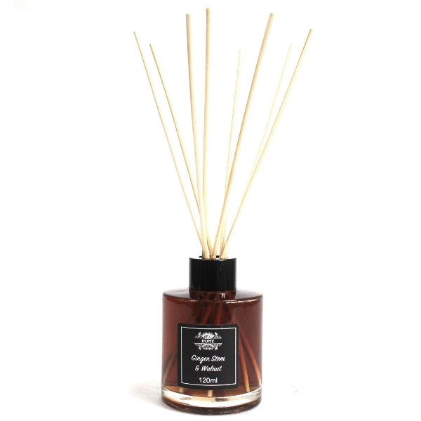 Reed diffuser with wooden sticks and a label on a white background