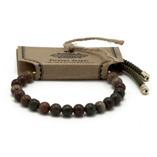 Bracelet with beads and gold accents on a white background