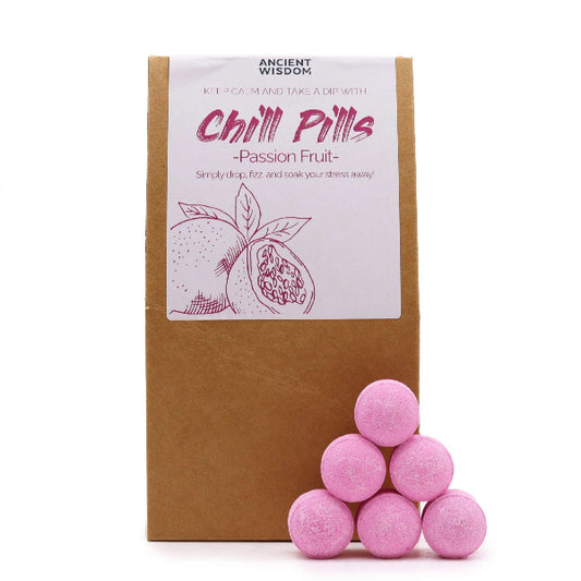 Pink bath bombs with a cardboard box labeled 'Chill Pills - Passion Fruit' on a white background