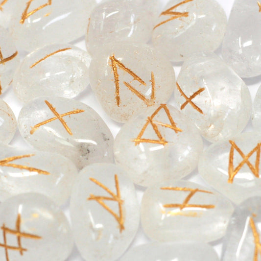Close-up of white stones with orange runes on a white background