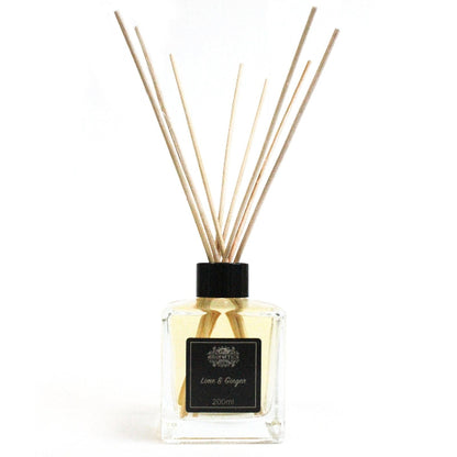 Reed diffuser with wooden sticks and a black cap on a white background