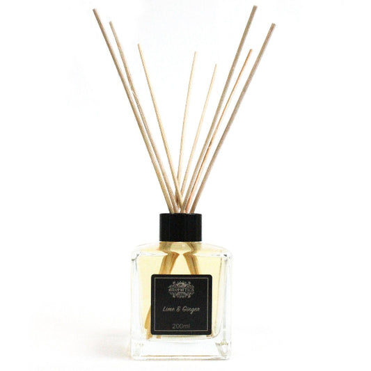 Reed diffuser with wooden sticks and a black cap on a white background