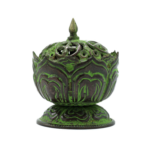 Decorative green and black incense burner on a white background