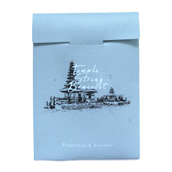 Light blue packaging with temple design and text on a white background
