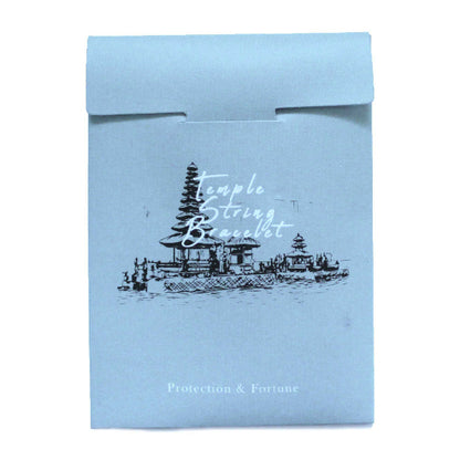 Light blue packaging with temple design and text on a white background