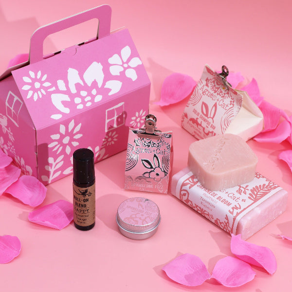 Cosmetic set with pink packaging on a pink background