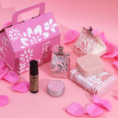 Cosmetic set with pink packaging on a pink background