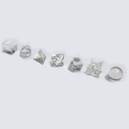 Collection of various crystal shapes on a light gray background