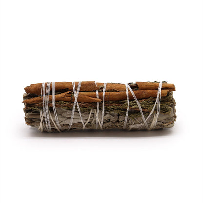 Rolled sage bundle with cinnamon sticks on a white background
