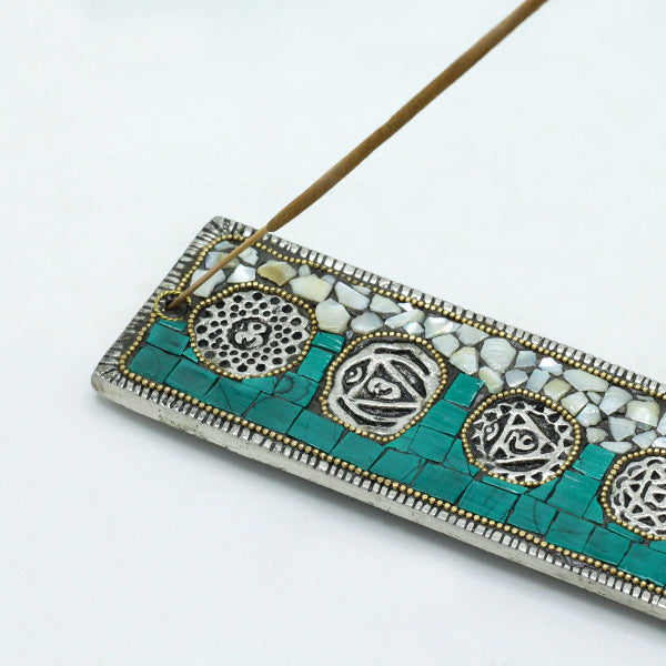 Decorative incense holder with turquoise mosaic design on a white background