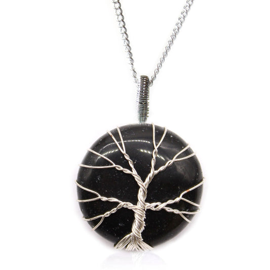 Black stone pendant with silver tree design on a white background