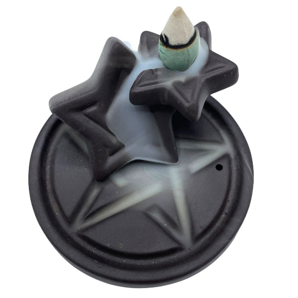 Star-shaped backflow incense burner with a cone incense on a white background