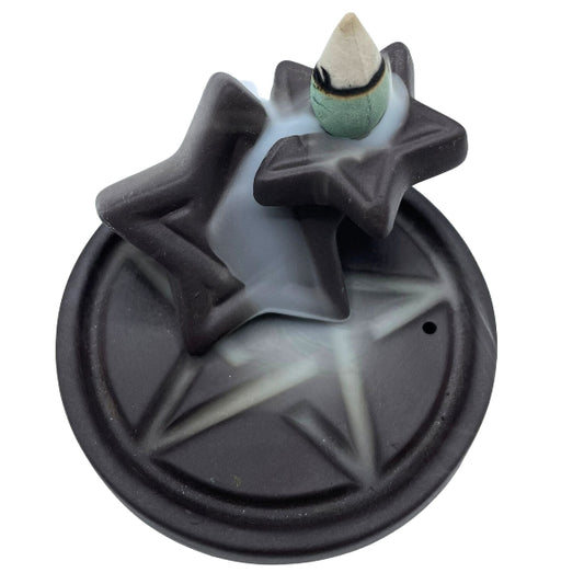 Star-shaped backflow incense burner with a cone incense on a white background