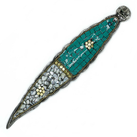 Decorative brooch with mosaic design on a white background
