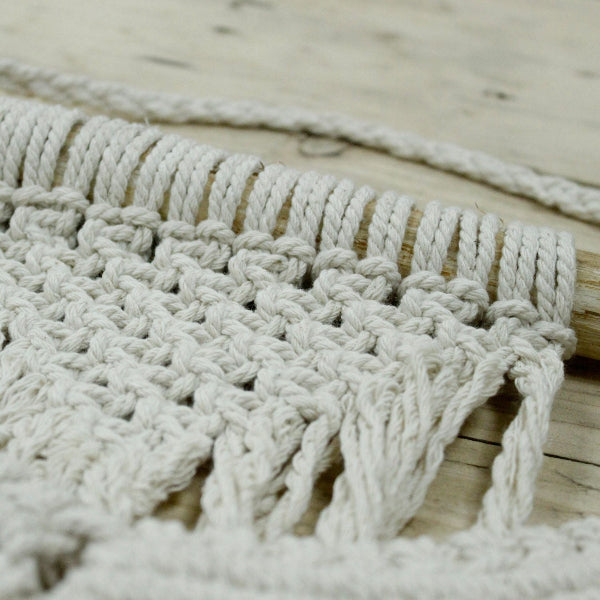 Close-up of a textured woven mat on a wooden surface
