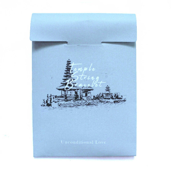 Light blue packaging box with temple design and text on a white background