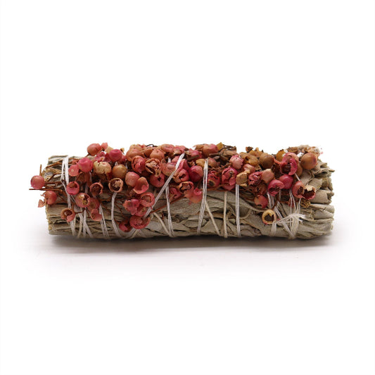 Bundled sage with pink and orange leaves on a white background