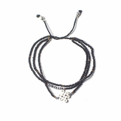 Multistrand beaded bracelet with metal clasp on a white background