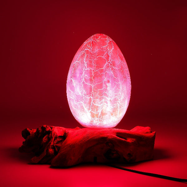 Glowing pink egg-like object on a red background