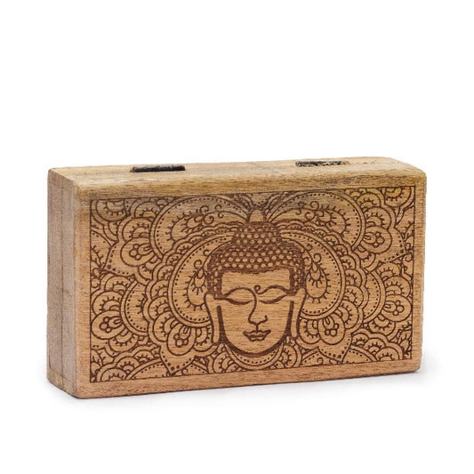 Wooden block with engraved Buddha face and mandala design on a white background