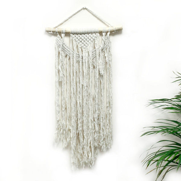 Macrame wall hanging with white yarn on a white background