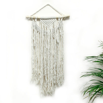 Macrame wall hanging with white yarn on a white background
