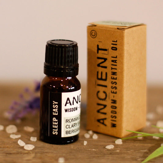 Bottle of 'Sleep Easy' essential oil with packaging on a wooden surface