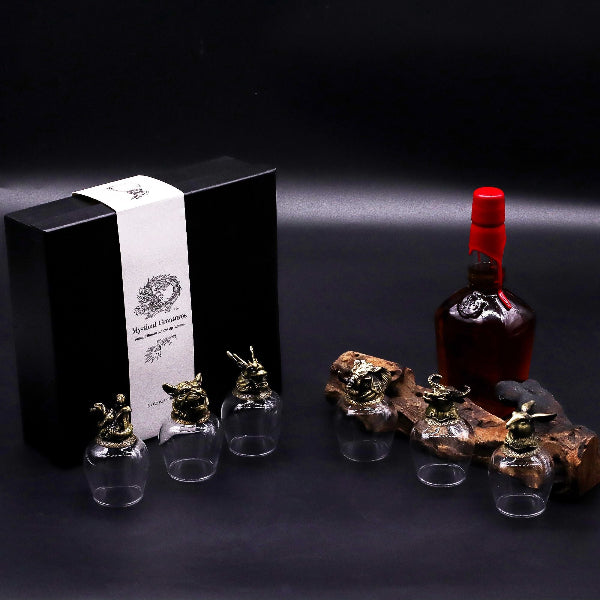 Bottle of red liquid with decorative elements on a dark background