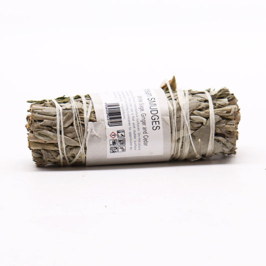 Rolled sage smudge stick with a label on a white background