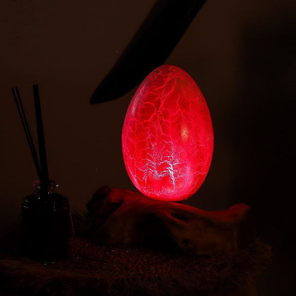 Red glowing egg-like object with cracked texture on a dark background