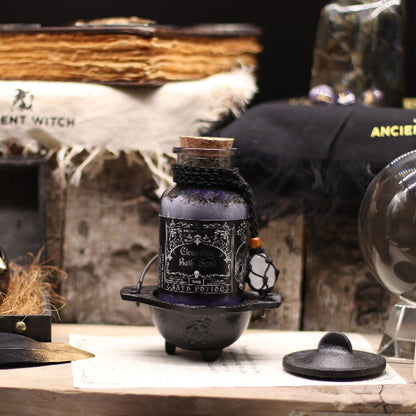 Decorative bottle with label on a rustic surface with witch-themed background