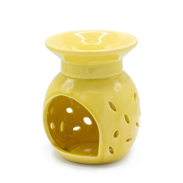 Yellow ceramic oil burner on a white background