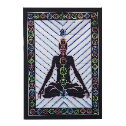 Tapestry with a central figure of a person in a meditative pose, surrounded by colorful chakra symbols on a white background.
