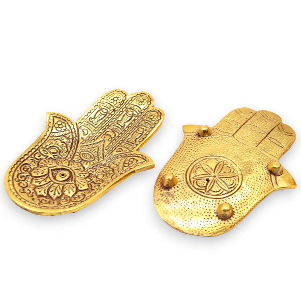 Two gold Hamsa hand ornaments on a white background