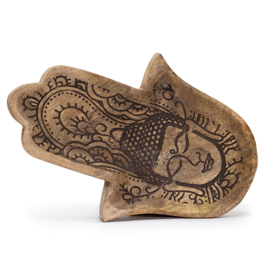 Wooden stamp with intricate designs on a white background